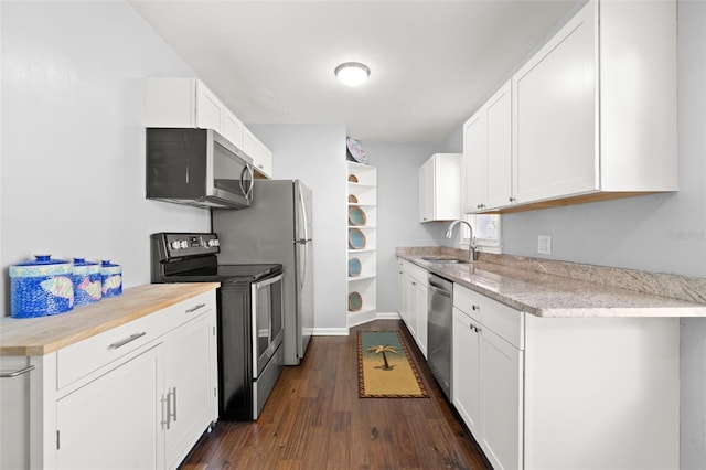 kitchen with stainless steel appliances, white cabinetry, sink, and dark hardwood / wood-style flooring