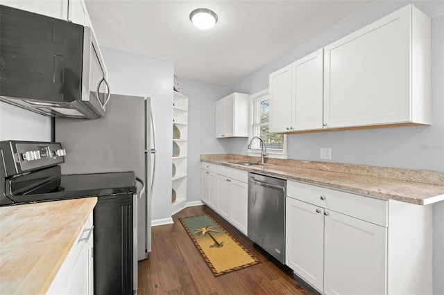 kitchen with white cabinetry, stainless steel appliances, dark hardwood / wood-style flooring, and sink