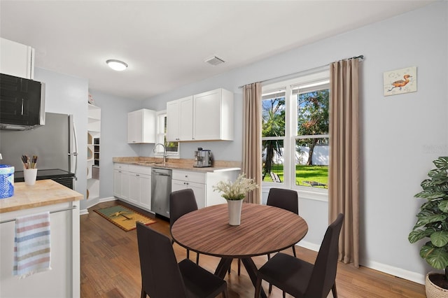 kitchen with sink, dishwasher, white cabinetry, dark hardwood / wood-style flooring, and beverage cooler