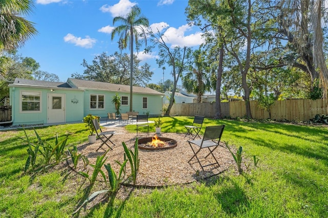 view of yard with a patio and an outdoor fire pit