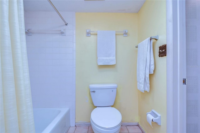 bathroom featuring shower / tub combo with curtain, tile patterned floors, and toilet