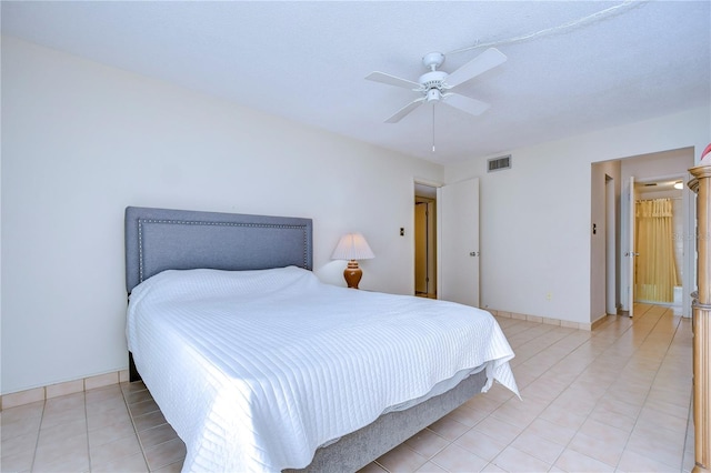 tiled bedroom featuring ceiling fan