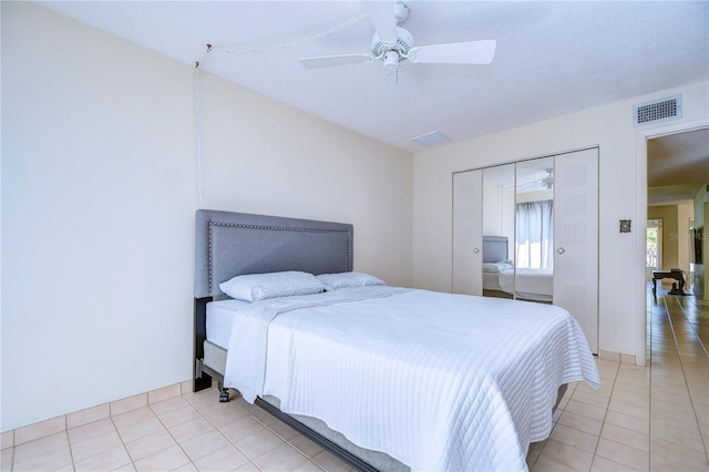 bedroom with a closet, ceiling fan, and light tile patterned flooring