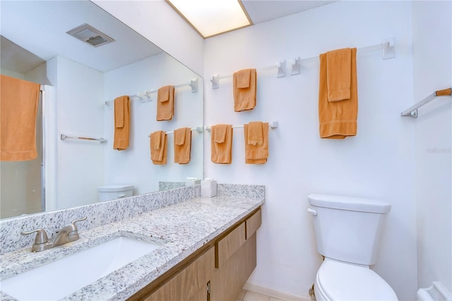 bathroom featuring vanity and toilet