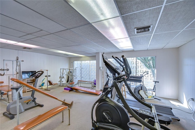 gym with a paneled ceiling