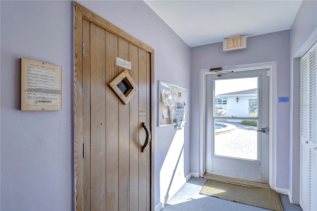 entryway with light colored carpet