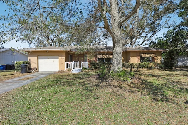 ranch-style house featuring a porch, a garage, and a front yard