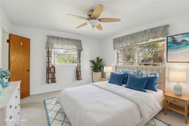 carpeted bedroom with ceiling fan