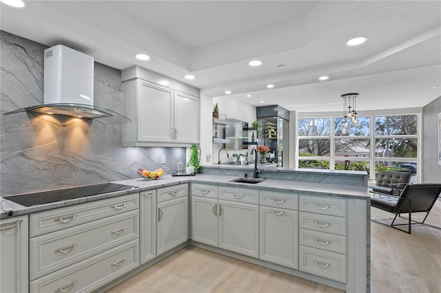 4951 Bacopa Ln S Unit 103, Saint Petersburg, FL 33715 - kitchen with decorative light fixtures, sink, exhaust hood, kitchen peninsula, and black electric cooktop