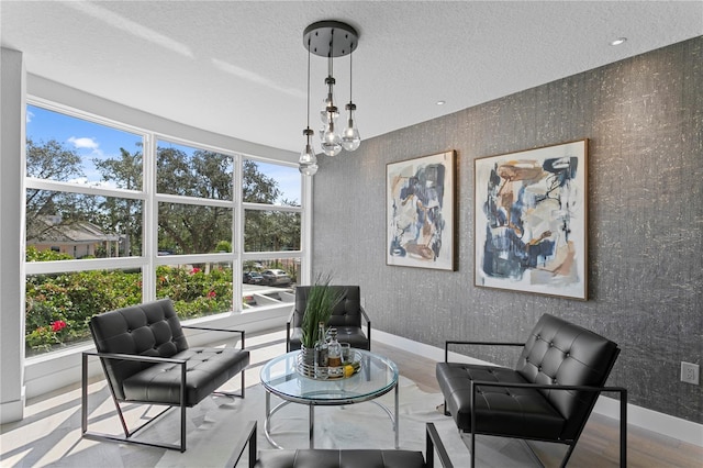 4951 Bacopa Ln S Unit 103, Saint Petersburg, FL 33715 - living area with a notable chandelier, wood-type flooring, and a textured ceiling