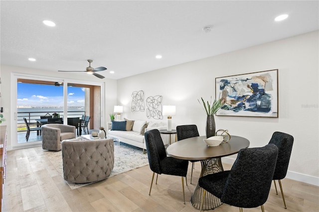 4951 Bacopa Ln S Unit 103, Saint Petersburg, FL 33715 - dining room with a water view, ceiling fan, and light hardwood / wood-style flooring