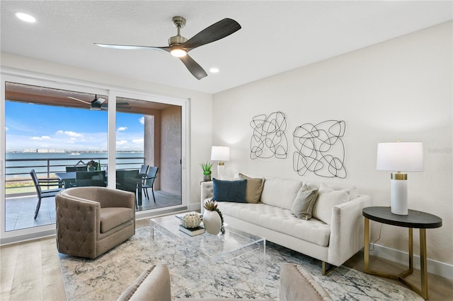 4951 Bacopa Ln S Unit 103, Saint Petersburg, FL 33715 - living room with wood-type flooring, a water view, and ceiling fan