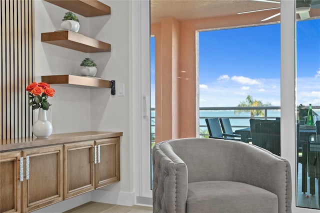 4951 Bacopa Ln S Unit 103, Saint Petersburg, FL 33715 - sitting room with a water view and ceiling fan
