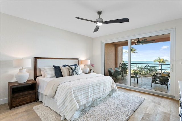 4951 Bacopa Ln S Unit 103, Saint Petersburg, FL 33715 - bedroom featuring light hardwood / wood-style flooring, access to outside, ceiling fan, and a water view
