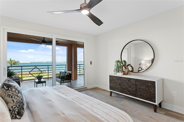 4951 Bacopa Ln S Unit 103, Saint Petersburg, FL 33715 - bedroom featuring access to outside, light hardwood / wood-style floors, ceiling fan, and a water view