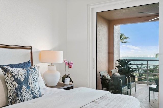 4951 Bacopa Ln S Unit 103, Saint Petersburg, FL 33715 - bedroom with a water view and light tile patterned floors