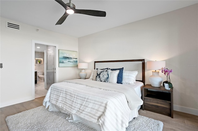 4951 Bacopa Ln S Unit 103, Saint Petersburg, FL 33715 - bedroom featuring light hardwood / wood-style flooring, ceiling fan, and ensuite bathroom