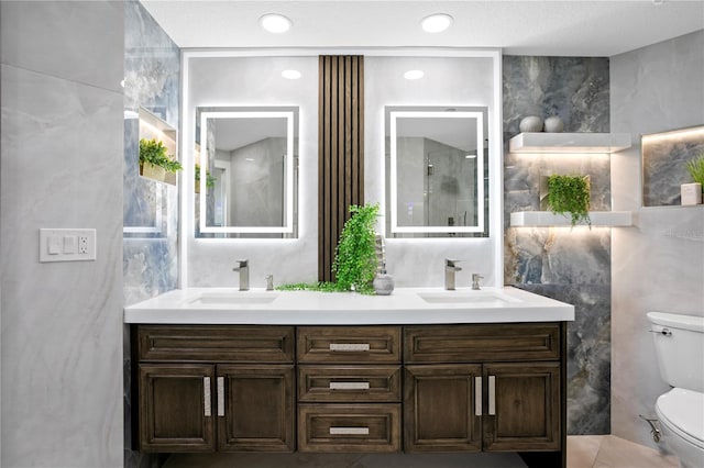 4951 Bacopa Ln S Unit 103, Saint Petersburg, FL 33715 - bathroom with vanity, tile walls, and toilet