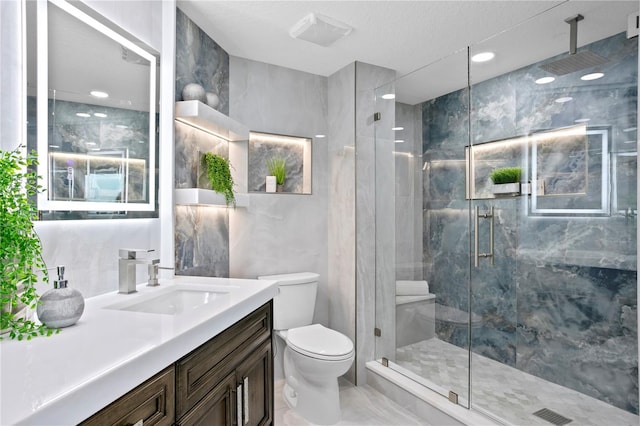4951 Bacopa Ln S Unit 103, Saint Petersburg, FL 33715 - bathroom featuring walk in shower, vanity, and toilet