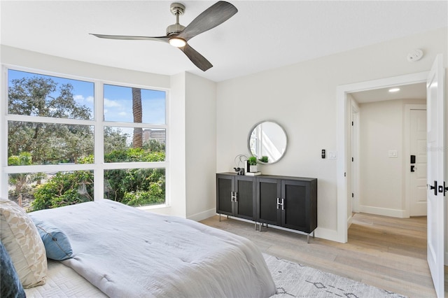 4951 Bacopa Ln S Unit 103, Saint Petersburg, FL 33715 - bedroom with ceiling fan, multiple windows, and light hardwood / wood-style flooring