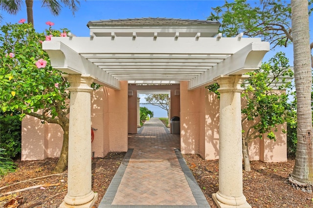4951 Bacopa Ln S Unit 103, Saint Petersburg, FL 33715 - doorway to property featuring a pergola