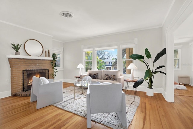 living room with ornamental molding, wood-type flooring, and a fireplace