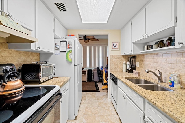 kitchen featuring electric range oven, white cabinetry, sink, stainless steel dishwasher, and light stone countertops