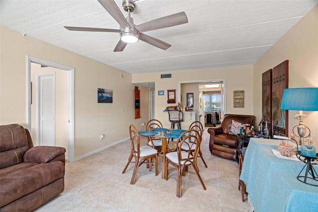 dining room with light tile patterned floors and ceiling fan