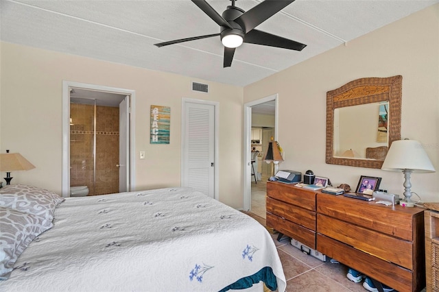 bedroom with light tile patterned floors, ceiling fan, and ensuite bathroom