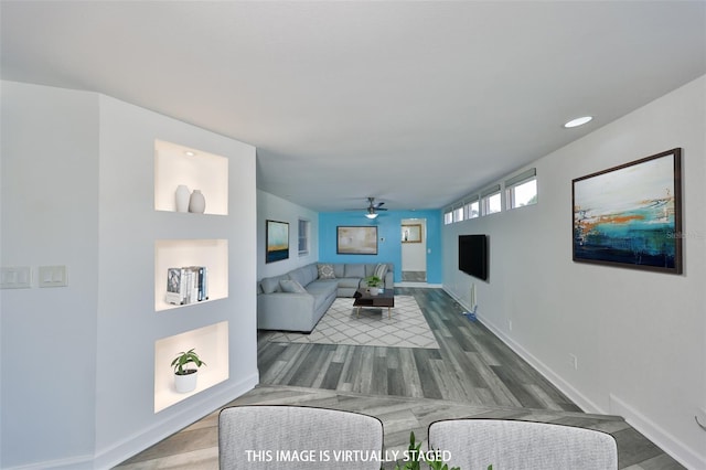 living room featuring hardwood / wood-style floors and ceiling fan