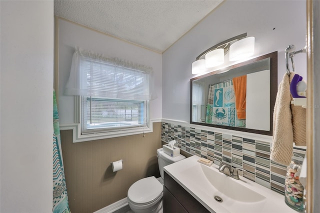 bathroom featuring vanity, toilet, and a textured ceiling