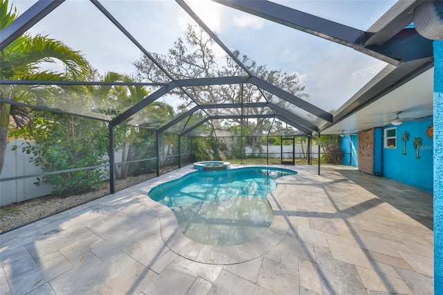 view of swimming pool featuring a patio, an in ground hot tub, ceiling fan, and glass enclosure