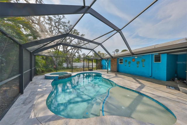 view of pool featuring an in ground hot tub, a lanai, and a patio