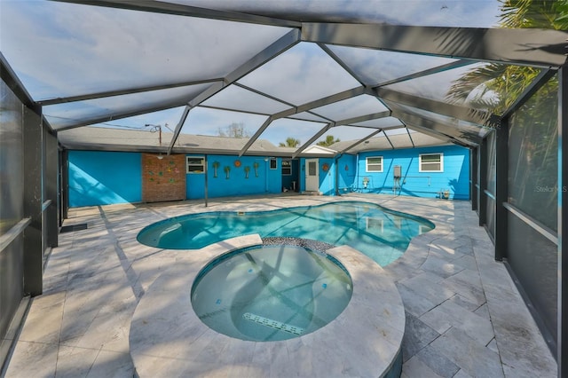 view of pool featuring an in ground hot tub, a lanai, and a patio area