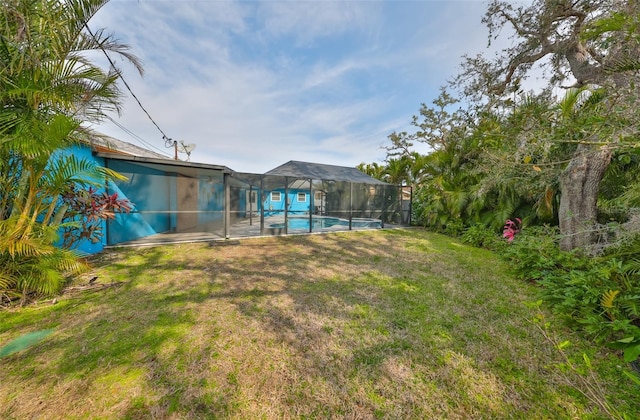 view of yard with glass enclosure