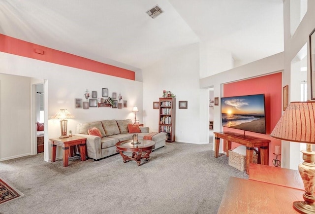 living area with carpet floors, baseboards, visible vents, and a high ceiling