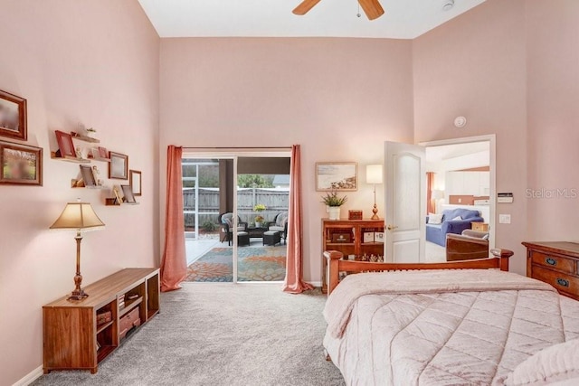 bedroom featuring access to exterior, carpet, ceiling fan, and a towering ceiling