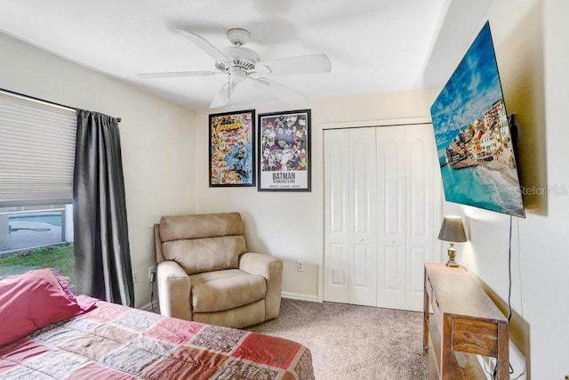 carpeted bedroom with a ceiling fan and a closet