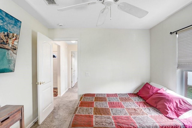 unfurnished bedroom featuring carpet flooring, ceiling fan, visible vents, and baseboards