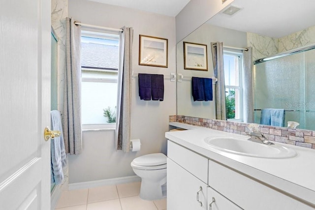 bathroom featuring plenty of natural light, a shower stall, toilet, and tile patterned floors