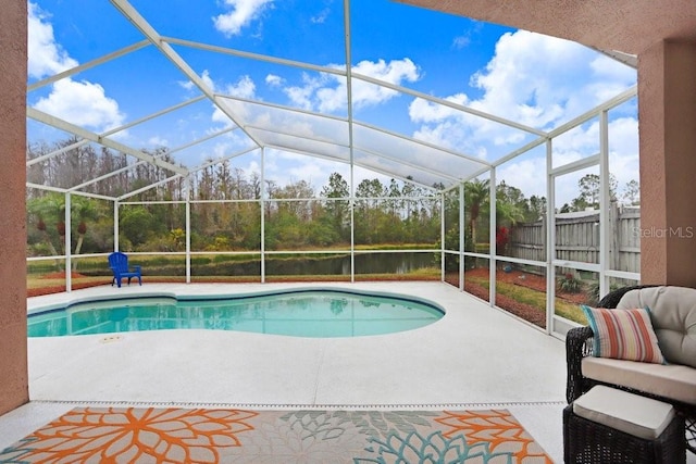 view of swimming pool with a patio area, glass enclosure, and a fenced in pool