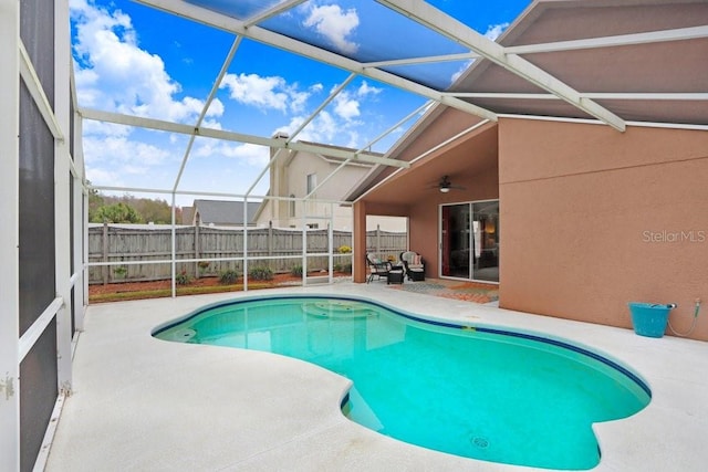 view of pool with a fenced in pool, a patio, ceiling fan, fence, and a lanai