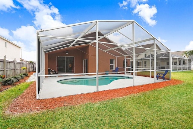 rear view of property with a patio, glass enclosure, fence, a lawn, and a fenced in pool