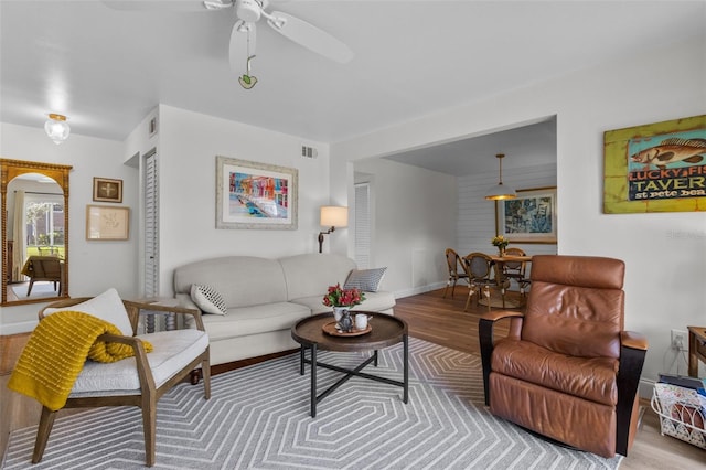 living room with ceiling fan and light wood-type flooring