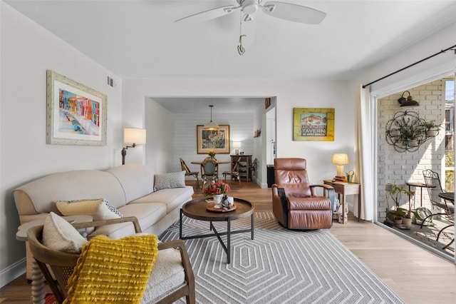 living room featuring ceiling fan and light wood-type flooring