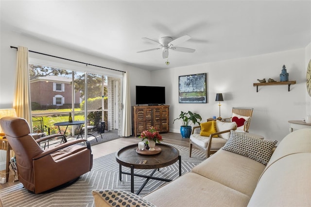 living room featuring light hardwood / wood-style flooring and ceiling fan