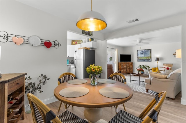 dining room featuring light hardwood / wood-style floors and ceiling fan