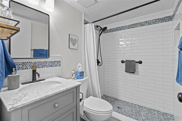 bathroom featuring vanity, walk in shower, a textured ceiling, and toilet