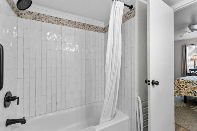 bathroom featuring shower / tub combo with curtain and ceiling fan