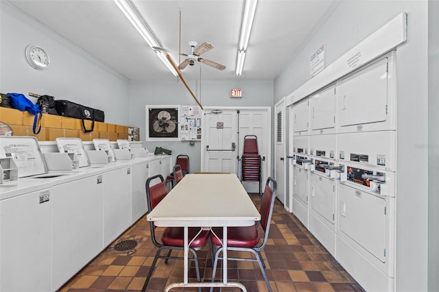 clothes washing area with stacked washing maching and dryer, ceiling fan, and washing machine and dryer